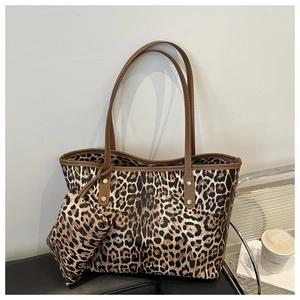 Detail of leopard print tote bag set with matching pouch on a minimalist background