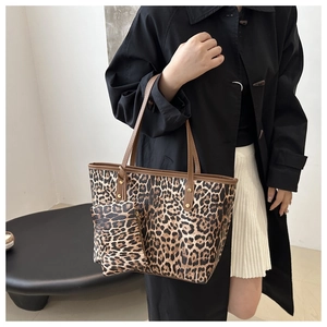 Detail view of large leopard print tote bag with matching small zippered inner pouch