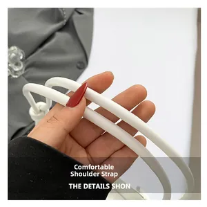 Detail of comfortable round white leather shoulder strap with litchi texture on handbag