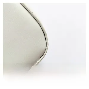 Close-up of fine stitching and premium leather texture on white shoulder bag