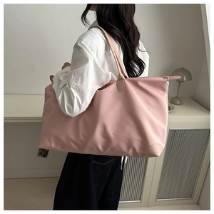 Macro detail of pink waterproof nylon tote bag with leather trim and zip closure