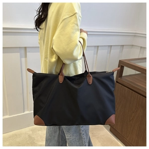 Close-up of the large capacity waterproof Oxford tote bag on a model's shoulder