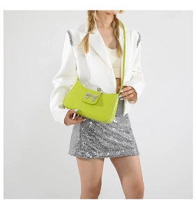 Detail of trendy lime green faux leather shoulder bag with silver butterfly hardware