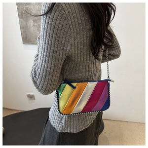 Detail of colorful metallic striped crossbody bag with silver bead trim and chain strap