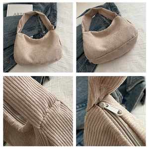 Macro detail of beige corduroy hobo bag texture and zipper closure on shoulder strap