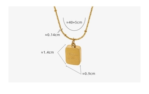 Macro detail of 18k gold plated square pendant with CHARM engraving and size dimensions