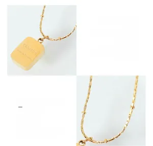 Detail of 18k gold plated titanium steel cube pendant with a beaded snake chain design