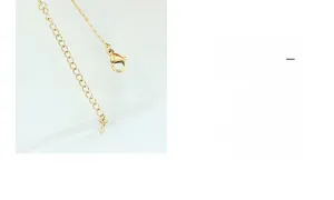 Macro view of gold chain necklace end with lobster clasp and adjustable links