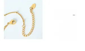 Detailed macro view of the K18 gold lobster clasp and adjustable extension chain link
