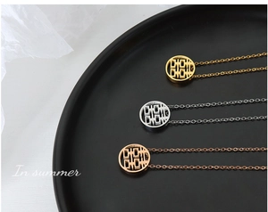 Detailed view of three circular necklaces in gold, silver, and rose gold with Xi character