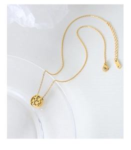 Detail of gold titanium steel Xi character hollow pendant necklace with K18 engraving