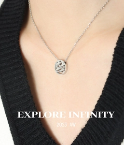 Close-up of a silver stainless steel necklace featuring a hollow Double Happiness pendant