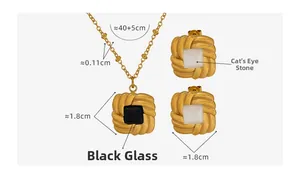 Detail of vintage gold-plated jewelry set showing cat eye stone and black glass inlays