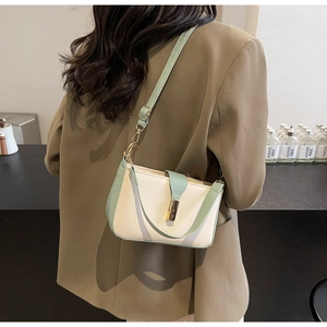 Detailed back view of a minimalist color-block crossbody square bag on a model