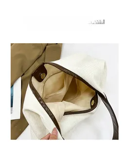 Macro view showing corduroy tote bag interior with zipper pocket and magnetic closure