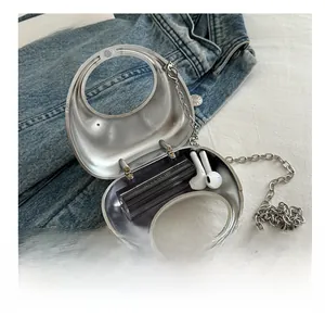 Macro view of silver metal mini bag capacity showing lipstick and earphones storage