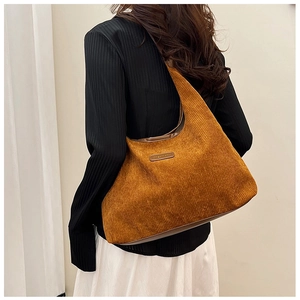 Fashionable ginger yellow corduroy hobo bag shown on a model for casual style