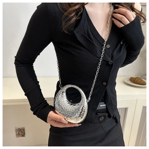 Detail of silver hammered texture mini bag with moon cutout and metal chain strap