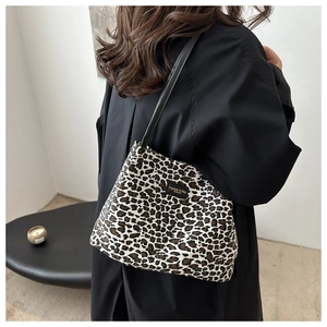 Foto lifestyle di una donna con borsa tote leopardata grande e manici neri in pelle