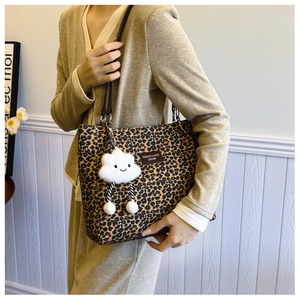 Leopard print tote bag with brown leather straps and a cute plush cloud charm detail