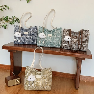Minimalist canvas tote bags in four colors with striped texture and plush cloud charms
