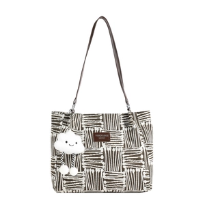 Striped canvas tote bag with brown shoulder straps and a white cloud plush charm