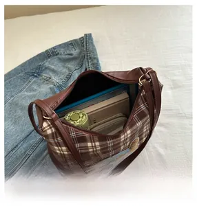 Interior view showing the large capacity of a brown checkered tote bag with daily items