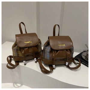 Detail of contrast plaid mini backpacks with leather trim and gold fashion lettering