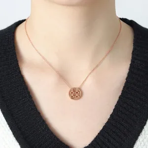 Rose gold stainless steel necklace with double happiness pendant on a model