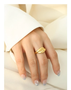Detail of 18K gold-plated chic layered ring with textured lines on a model's finger