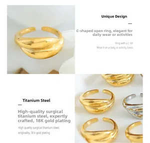 Detailed close-up of C-shaped open rings in 18K gold and silver plated titanium steel