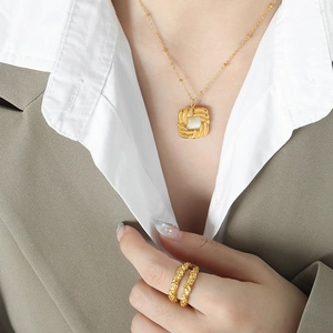 French vintage titanium gold necklace with square cat-eye stone and textured rings