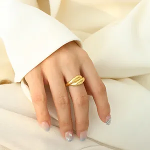Polished 18K gold-plated chunky ribbed ring styled on a model in chic fashion