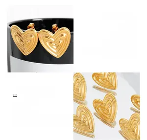 Detailed view of 18K gold plated heart earrings with unique wavy texture on titanium steel