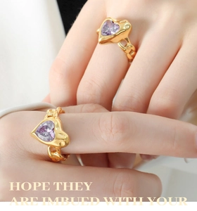 Macro detail of heart-shaped purple zircon ring with golden cuban chain texture band