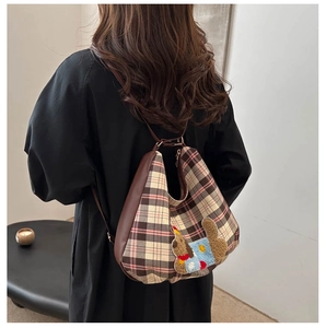 Detailed back view of a brown plaid tote bag with a cute 3D cartoon dog embroidery