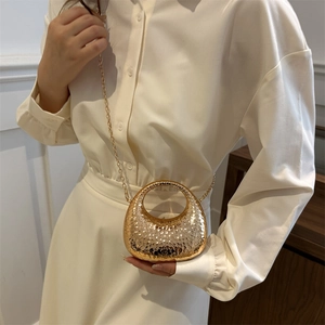 Mini gold chain handbag with hammered texture for women shown in a lifestyle pose