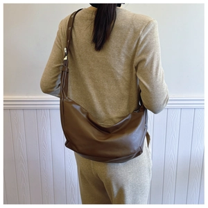 Detail of dark brown leather Hobo bag showing soft texture and large capacity for women