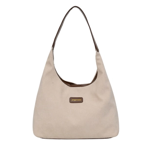Chic beige corduroy tote bag with brown leather handles for spring fashion 2025