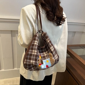 Brown plaid tote bag for women featuring a plush puppy patch and leather shoulder strap