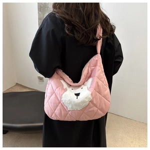 Rear view of a model wearing the pink quilted tote bag with a plush dog patch