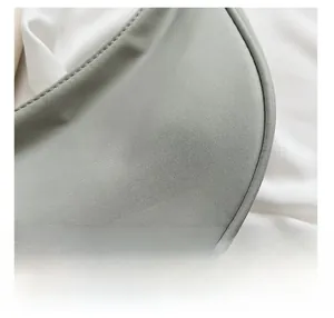Close-up of high-density light gray nylon fabric texture and reinforced stitching details