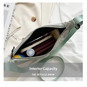 Internal view of sage green nylon crossbody bag showing spacious capacity and daily items