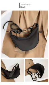 Detailed views of a black nylon crescent crossbody bag with adjustable strap and zip closure
