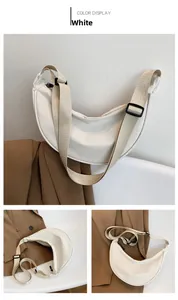 Detail view of white crescent nylon crossbody bag with adjustable strap and zipper closure