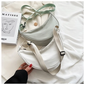 Detail of minimalist nylon half-moon crossbody bags with adjustable wide shoulder straps