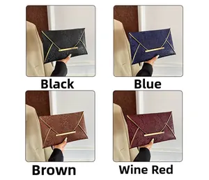 Close-up of four embossed leather envelope clutches in black, blue, brown, and wine red