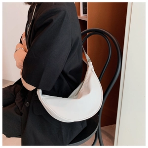 Close-up of a white crescent moon nylon shoulder bag with a secure zipper closure