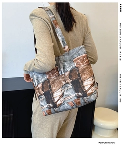 Model wearing a large printed tote bag in denim texture for a stylish commuter look