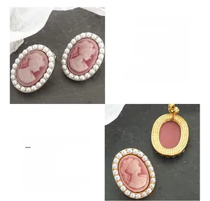 Detail of pink cameo earrings with white pearls and 18K gold plated titanium steel